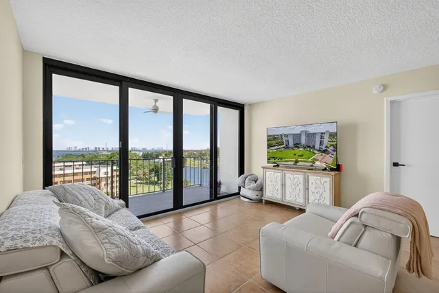 a view of a city from a balcony with furniture