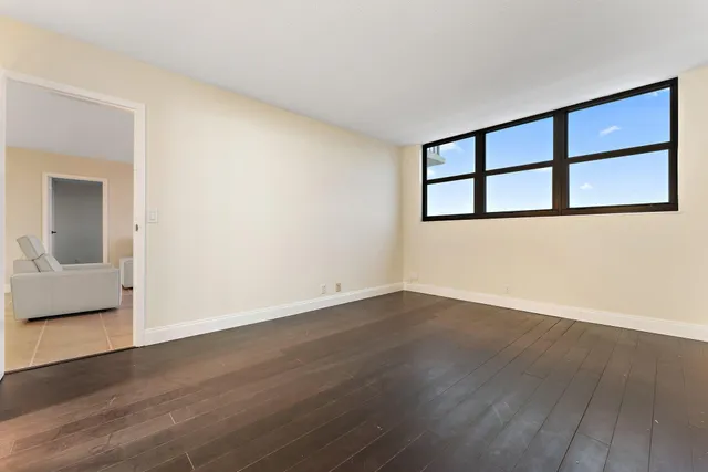a room with pool table and windows