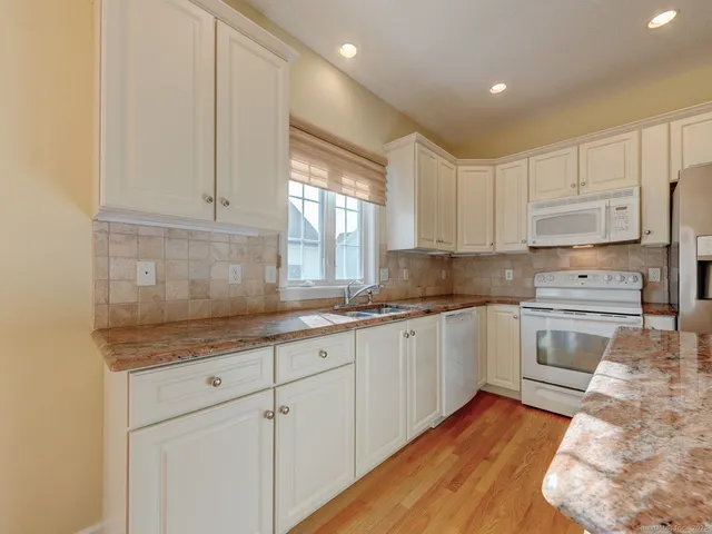 a white refrigerator freezer sitting in a kitchen