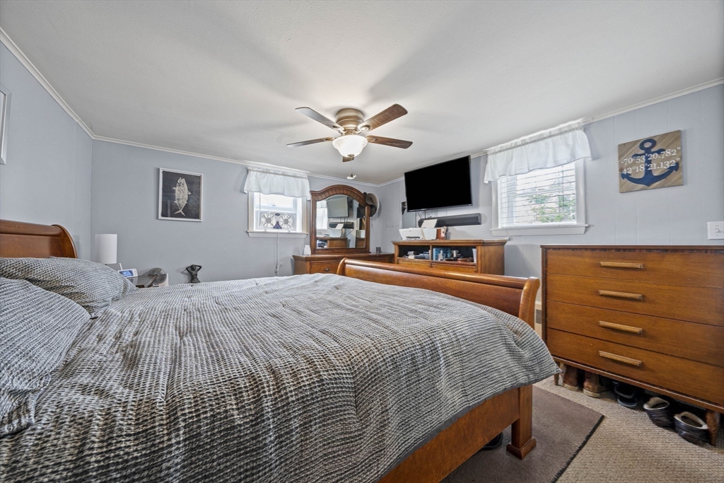 15 D Street Hull, MA 02045 - Photo 19 of 42 a bed room with a bed and a television