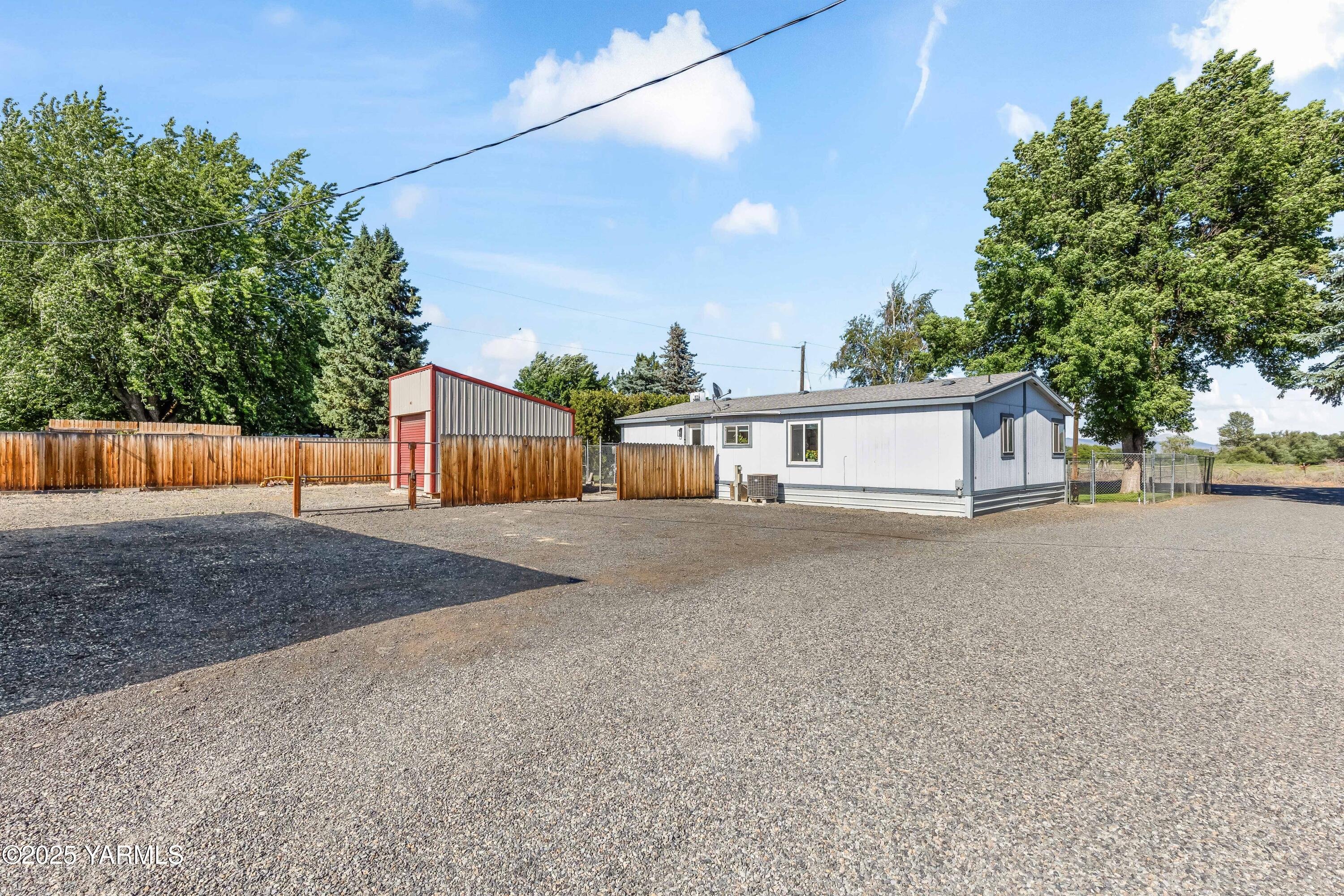 3404 Stanton Road Yakima, WA 98903 - Photo 22 of 37 a front view of a house with a yard and garage