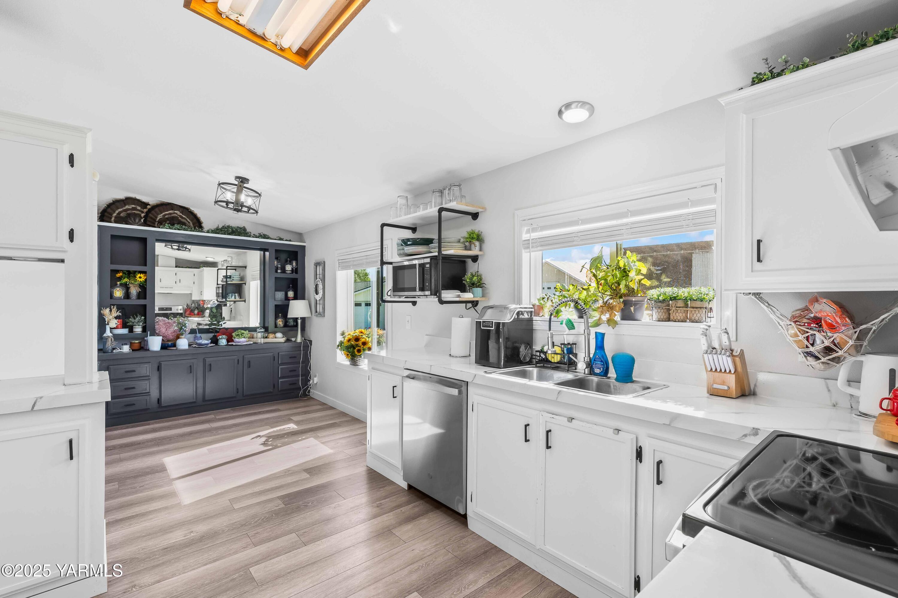 3404 Stanton Road Yakima, WA 98903 - Photo 10 of 37 a kitchen with a sink and wooden floor