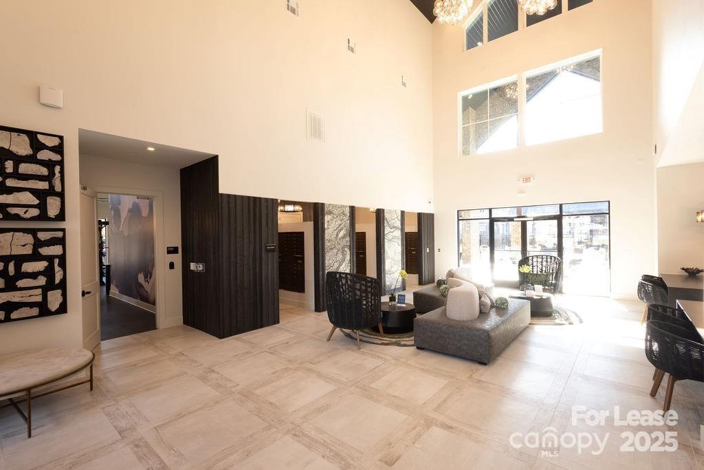 3110 Doe River Way, Unit WHITBY Matthews, NC 28105 - Photo 16 of 48 a living room with furniture a flat screen tv and large window