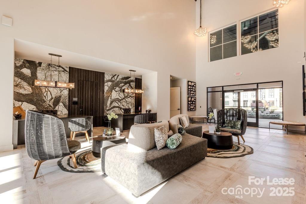 3110 Doe River Way, Unit WHITBY Matthews, NC 28105 - Photo 5 of 48 a living room with furniture gym equipment and a floor to ceiling window