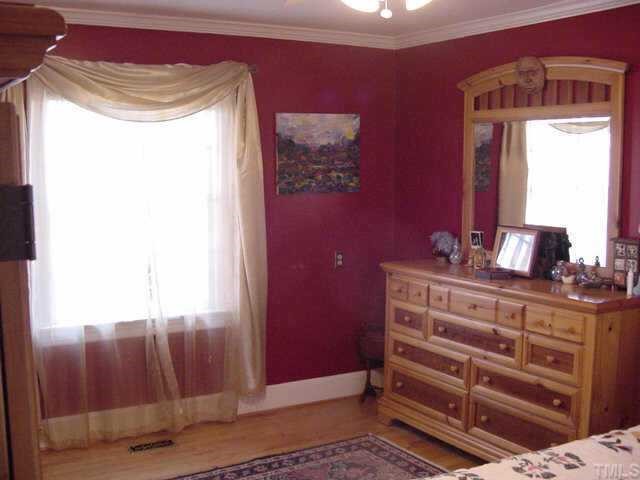 1101 Bancroft Street Raleigh, NC 27612 - Photo 6 of 10 a view of a bedroom with a bed and a mirror