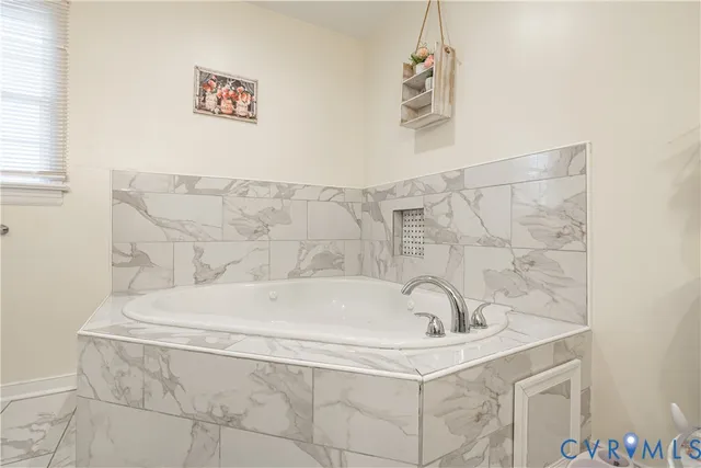 a spacious bathroom with a toilet sink and mirror