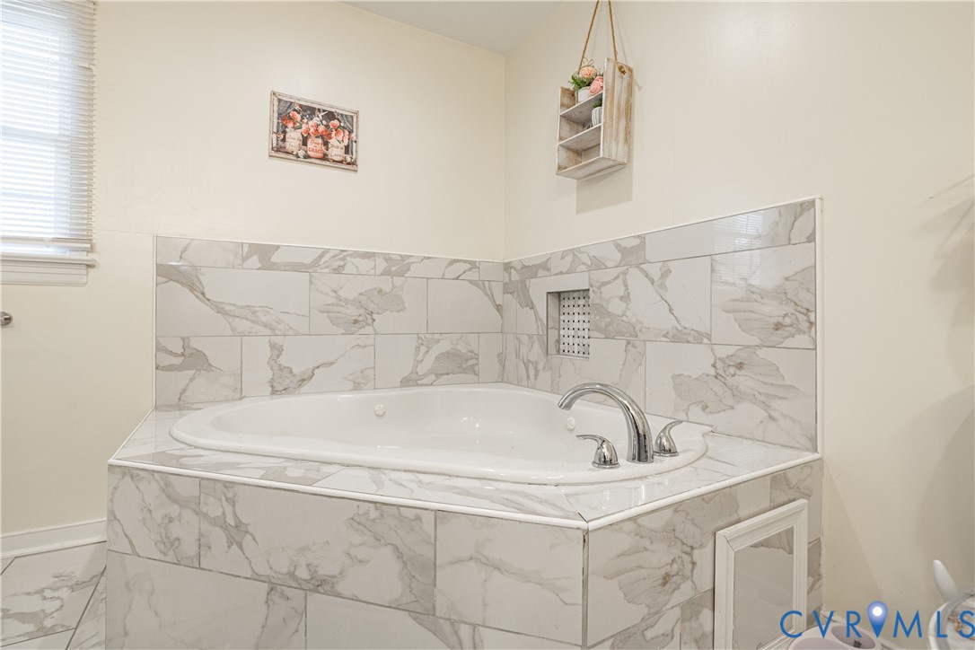 1920 Meadow Road Sandston, VA 23150 - Photo 10 of 30 a bath tub sitting next to a white sink