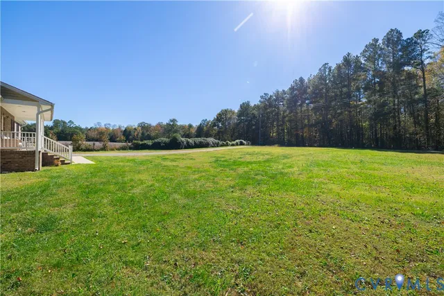 a view of a balcony with yard