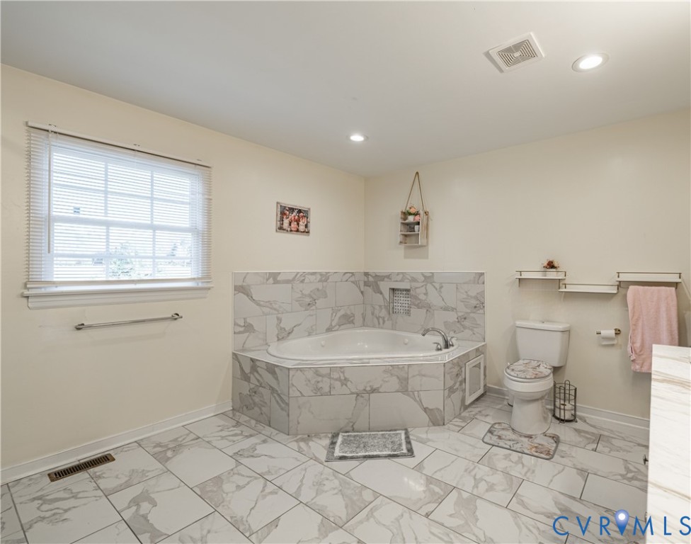 1920 Meadow Road Sandston, VA 23150 - Photo 9 of 30 a spacious bathroom with a toilet sink and mirror