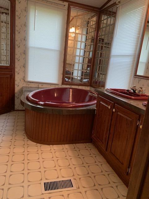 5552 Ferrum Mountain Road Callaway, VA 24067 - Photo 11 of 21 a bathroom with a sink a toilet and mirror
