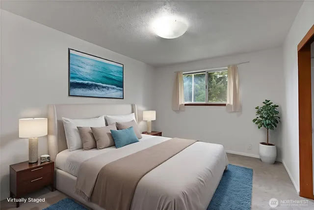 a bedroom with bed and a potted plant