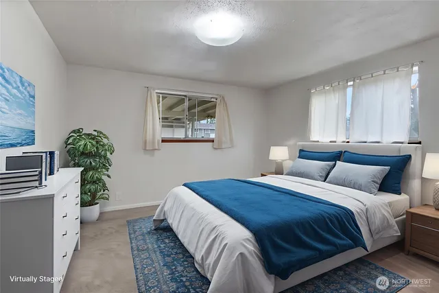 a bedroom with a bed and a potted plant