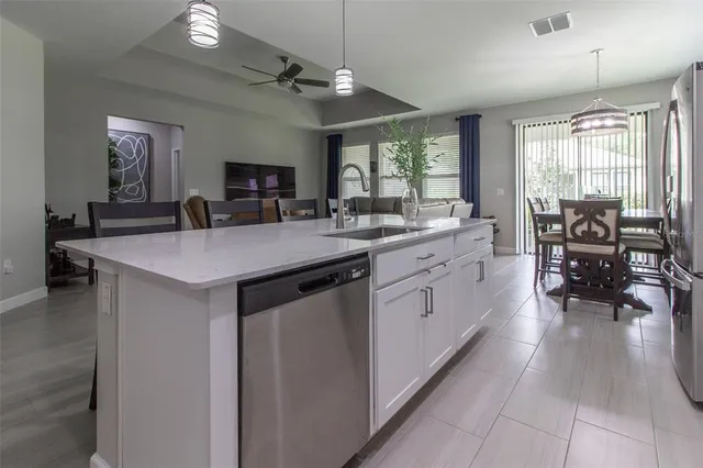a view of a dining room with furniture and large windows