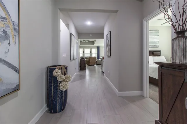 a view of a hallway with furniture and a living room