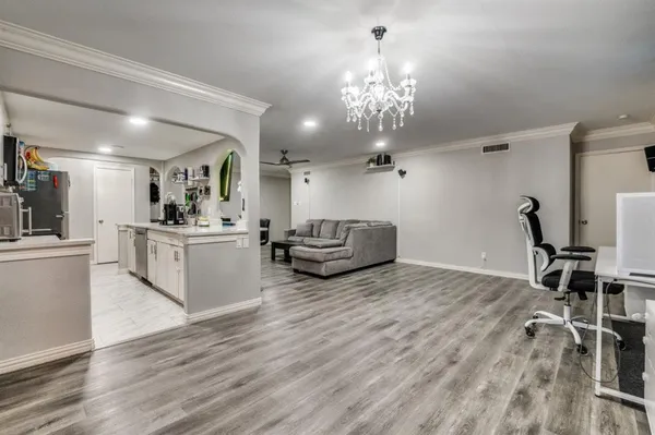 a living room with furniture and a chandelier
