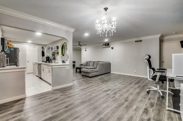 a living room with furniture and a chandelier