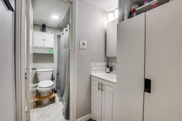 a bathroom with a toilet sink and a shower