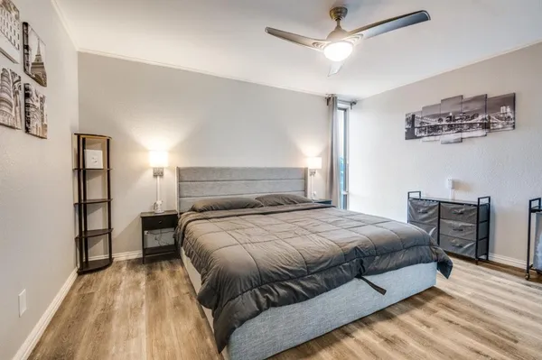 a bedroom with a bed and a chandelier