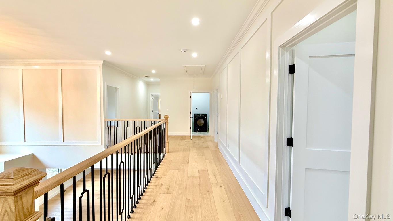 60 Periwinkle Road Levittown, NY 11756 - Photo 16 of 33 a view of a hallway with wooden floor and staircase