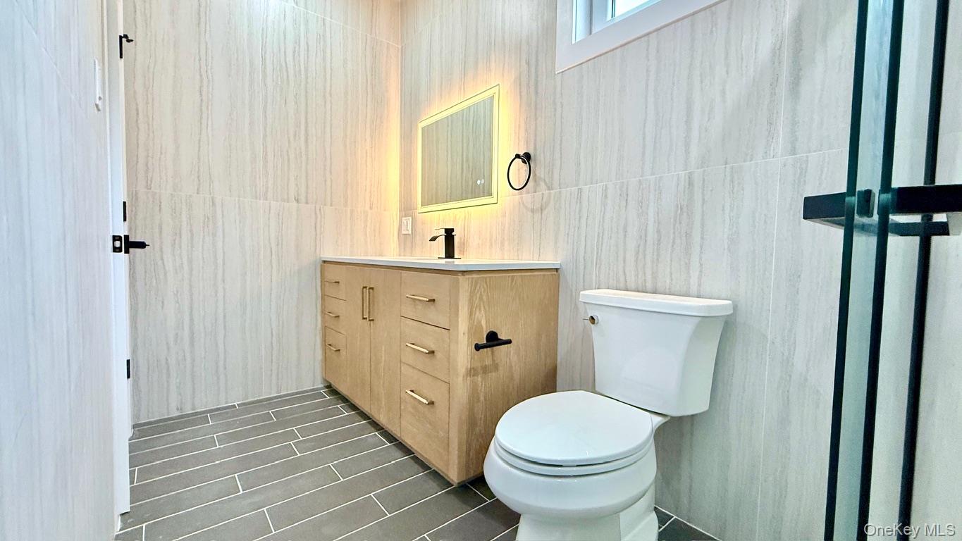 60 Periwinkle Road Levittown, NY 11756 - Photo 28 of 33 a bathroom with a sink a toilet and shower curtain