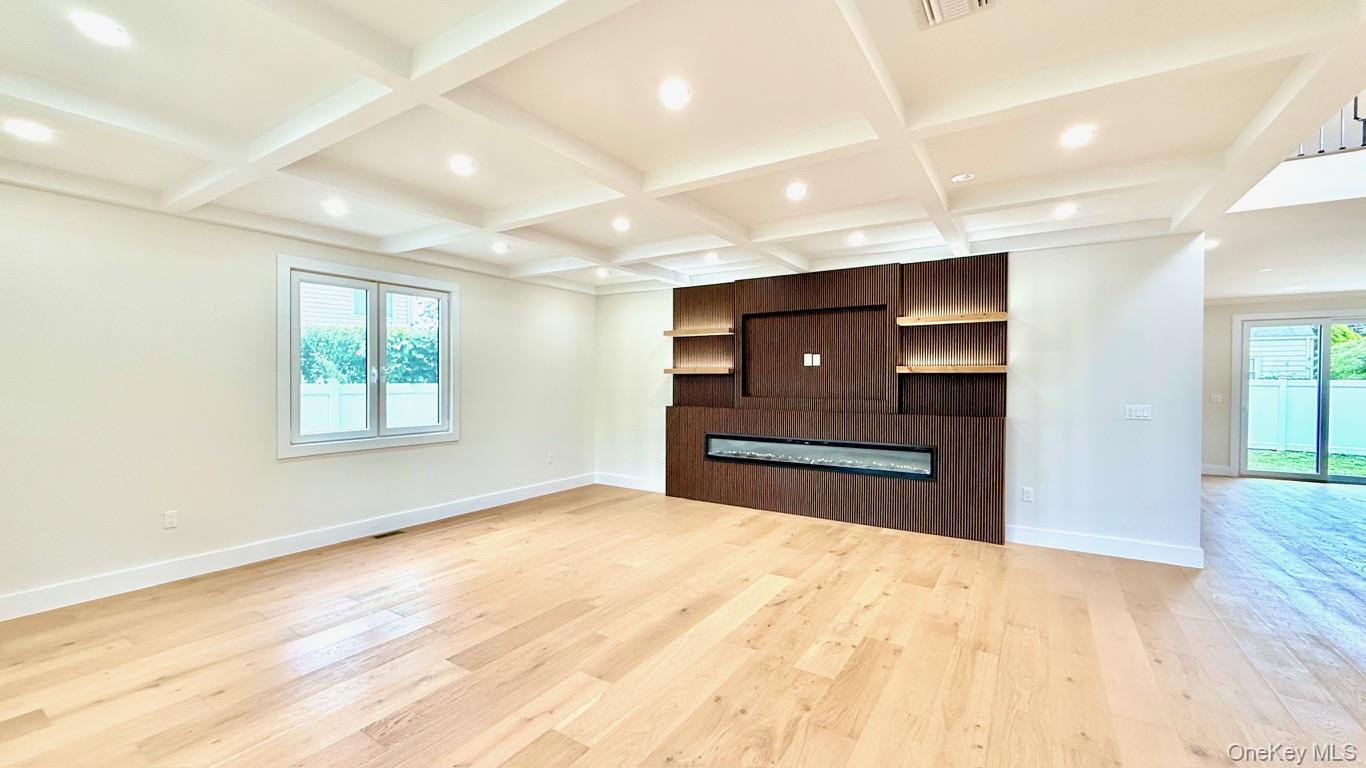 60 Periwinkle Road Levittown, NY 11756 - Photo 6 of 33 a view of kitchen and empty room with wooden floor