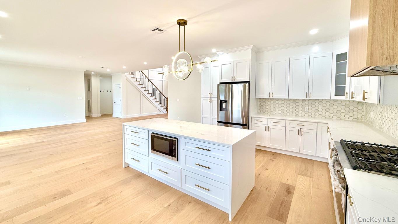 60 Periwinkle Road Levittown, NY 11756 - Photo 10 of 33 a kitchen with a stove a sink and a refrigerator