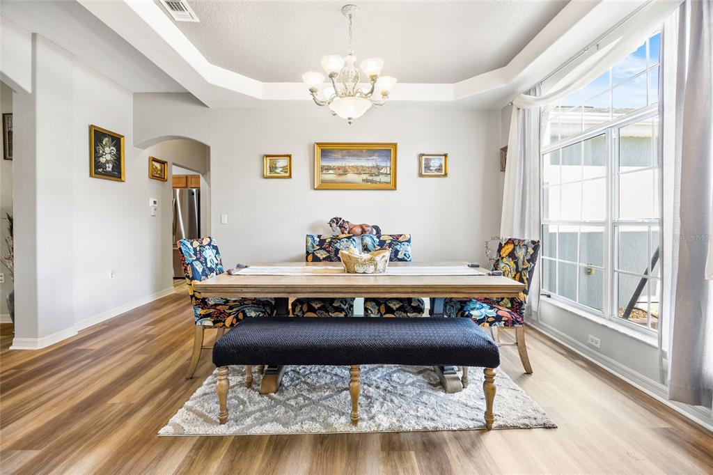 15092 Southwest 14th Avenue Road Ocala, FL 34473 - Photo 2 of 40 a view of a dining room with furniture wooden floor and chandelier