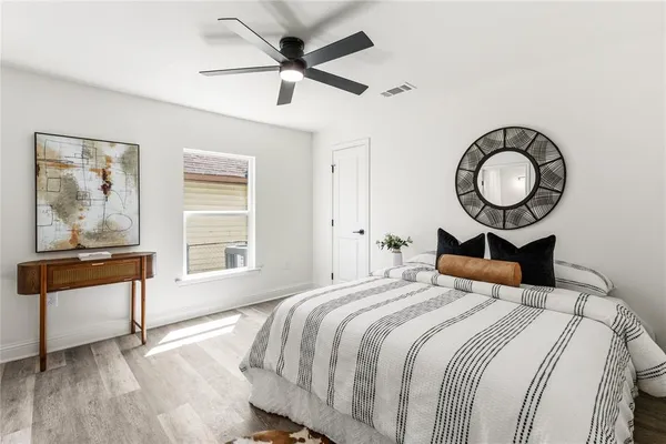 a bedroom with a bed and wooden floor