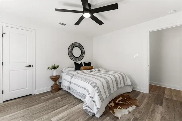 a bedroom with a bed and a ceiling fan
