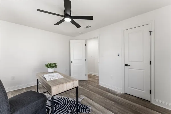 an empty room with a window and wooden floor