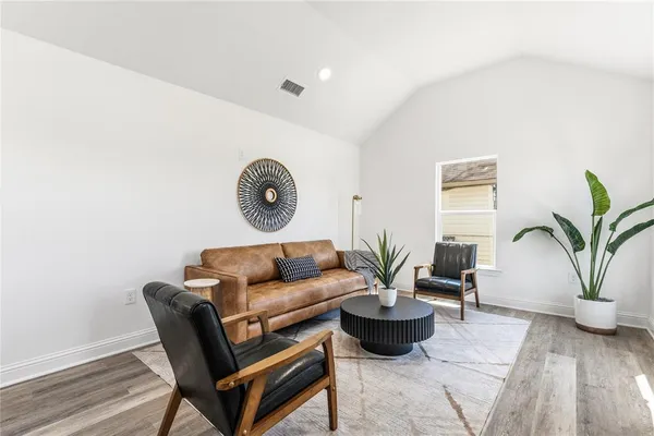a living room with furniture and a potted plant