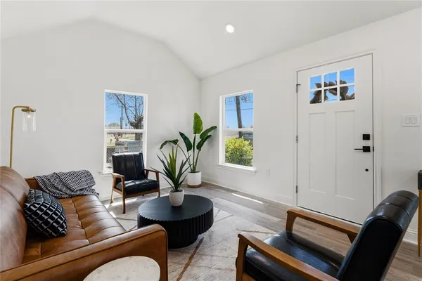 a living room with furniture potted plant and a window