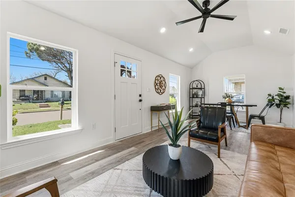 a living room with furniture and a potted plant