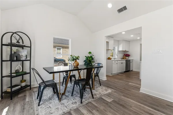 a view of a dining room with furniture and a window