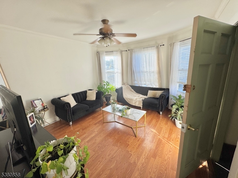 206 North 6th Street Prospect Park, NJ 07508 - Photo 12 of 18 a living room with furniture and a chandelier