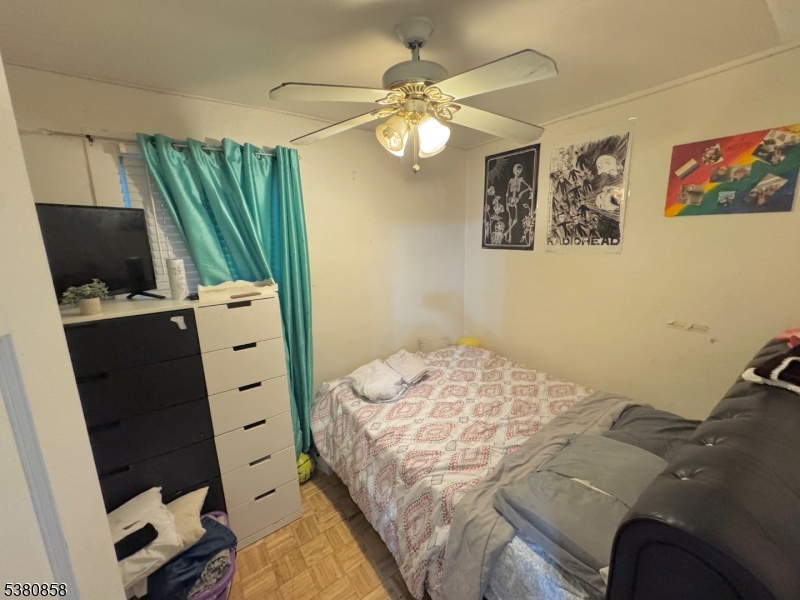 206 North 6th Street Prospect Park, NJ 07508 - Photo 14 of 18 a bedroom with a bed and a television