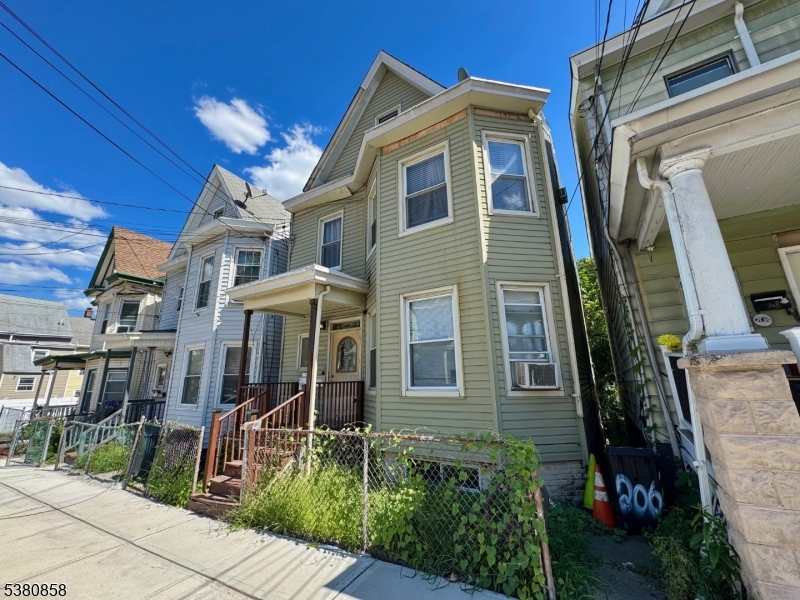 206 North 6th Street Prospect Park, NJ 07508 - Photo 3 of 18 a front view of a house with a yard