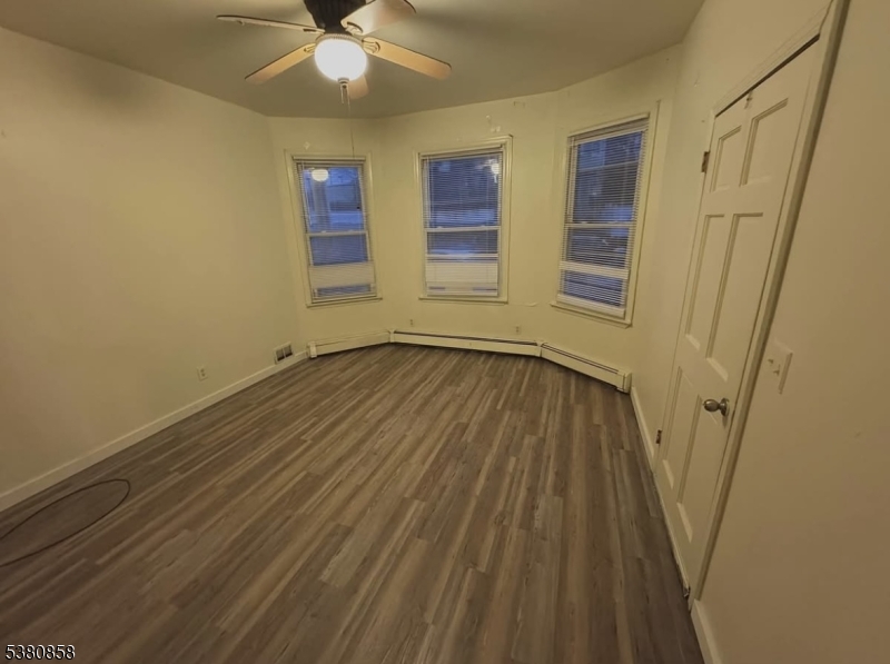 206 North 6th Street Prospect Park, NJ 07508 - Photo 6 of 18 wooden floor in an empty room with a window