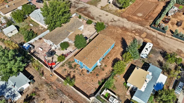 an aerial view of a city with lots of residential buildings ocean and mountain view in back