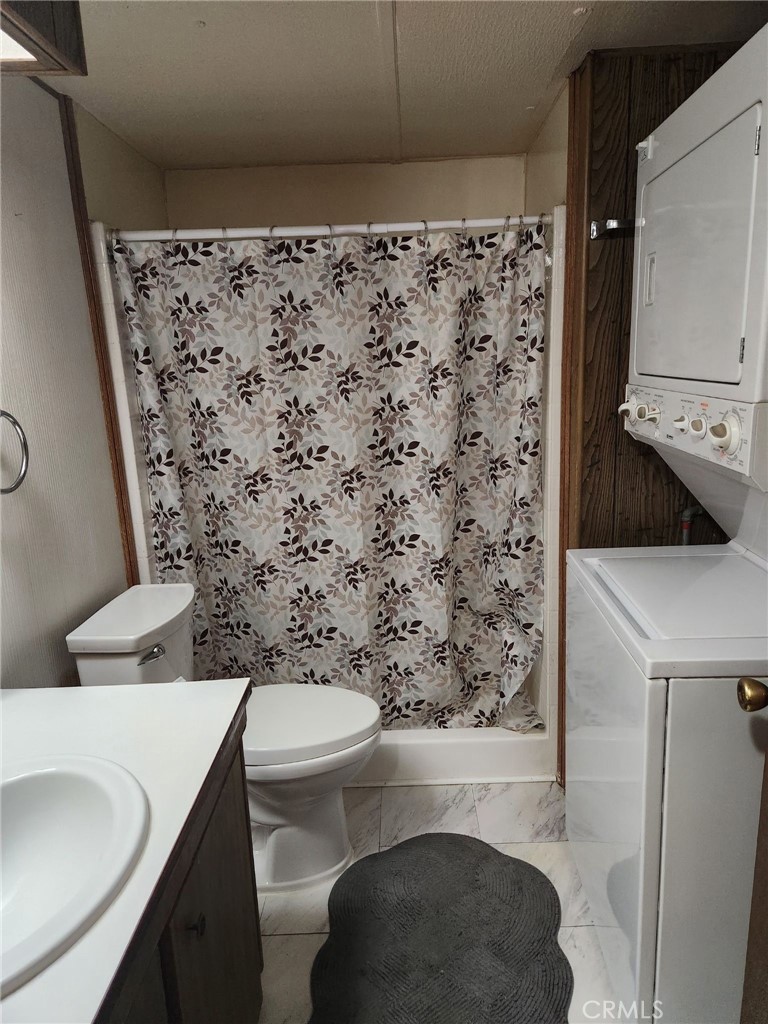 15940 Stoddard Wells Road, Unit 30 Victorville, CA 92395 - Photo 12 of 17 Stall shower and laundry appliances.