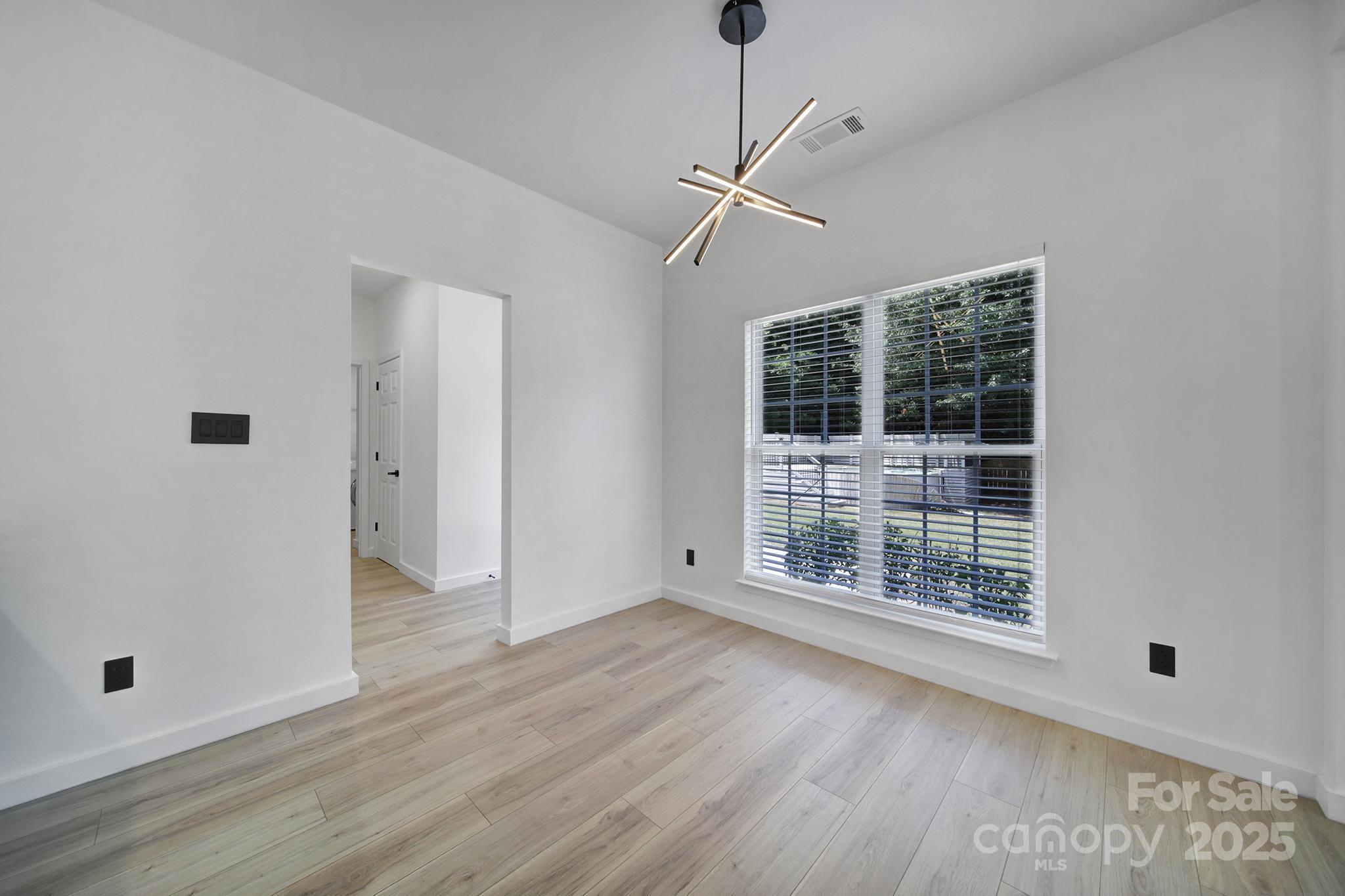 13425 Meadowmere Road Huntersville, NC 28078 - Photo 11 of 41 a view of an empty room with wooden floor and a window