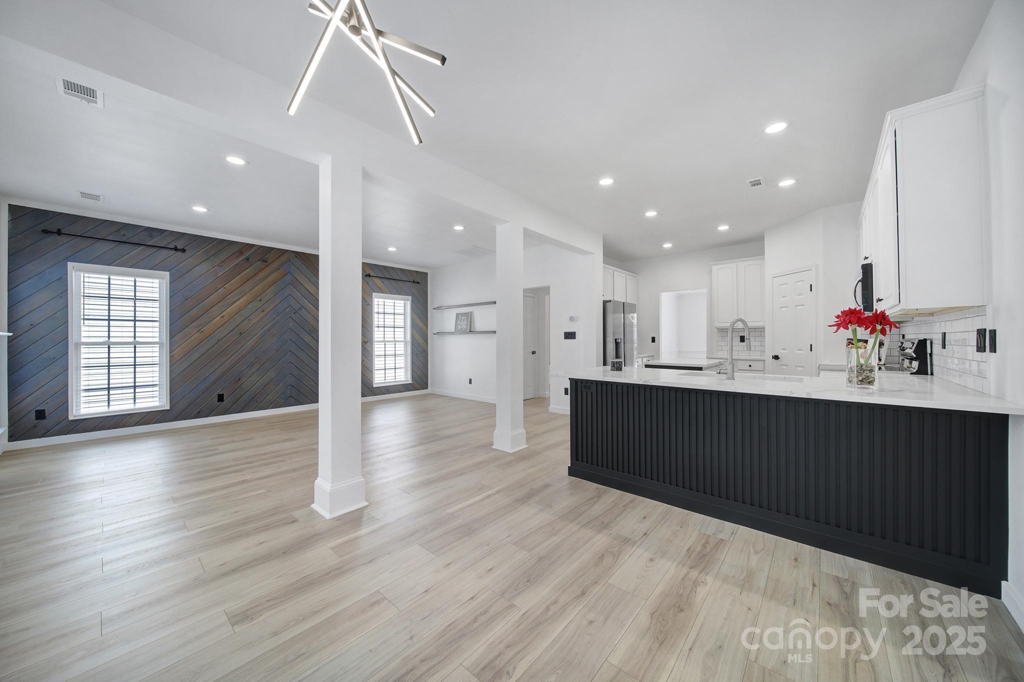 13425 Meadowmere Road Huntersville, NC 28078 - Photo 12 of 41 a living room with wooden floors and kitchen view