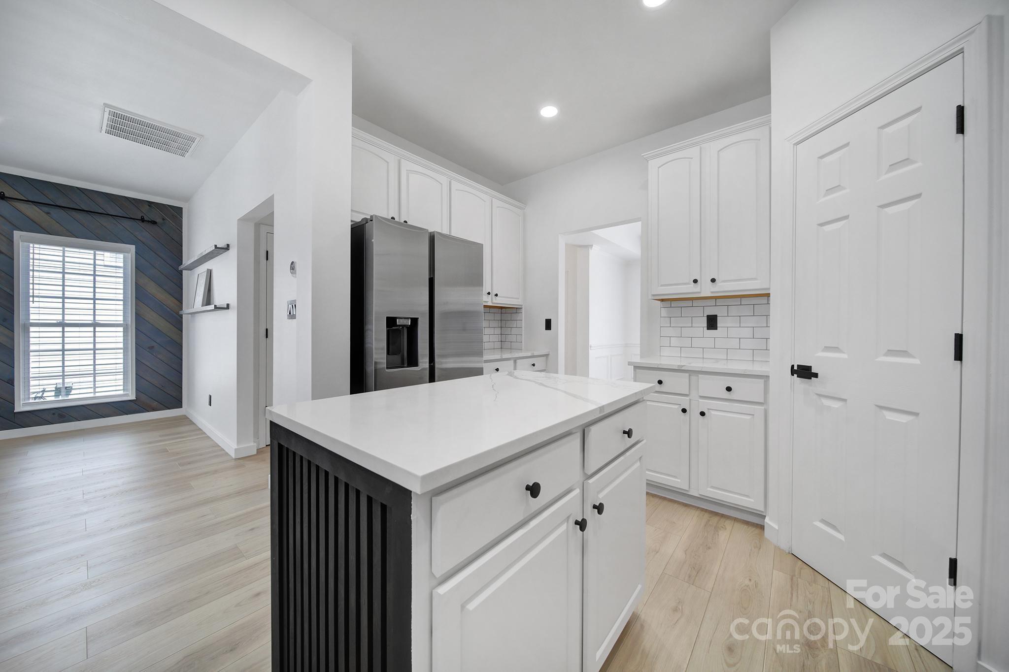 13425 Meadowmere Road Huntersville, NC 28078 - Photo 16 of 41 a kitchen with white cabinets and stainless steel appliances