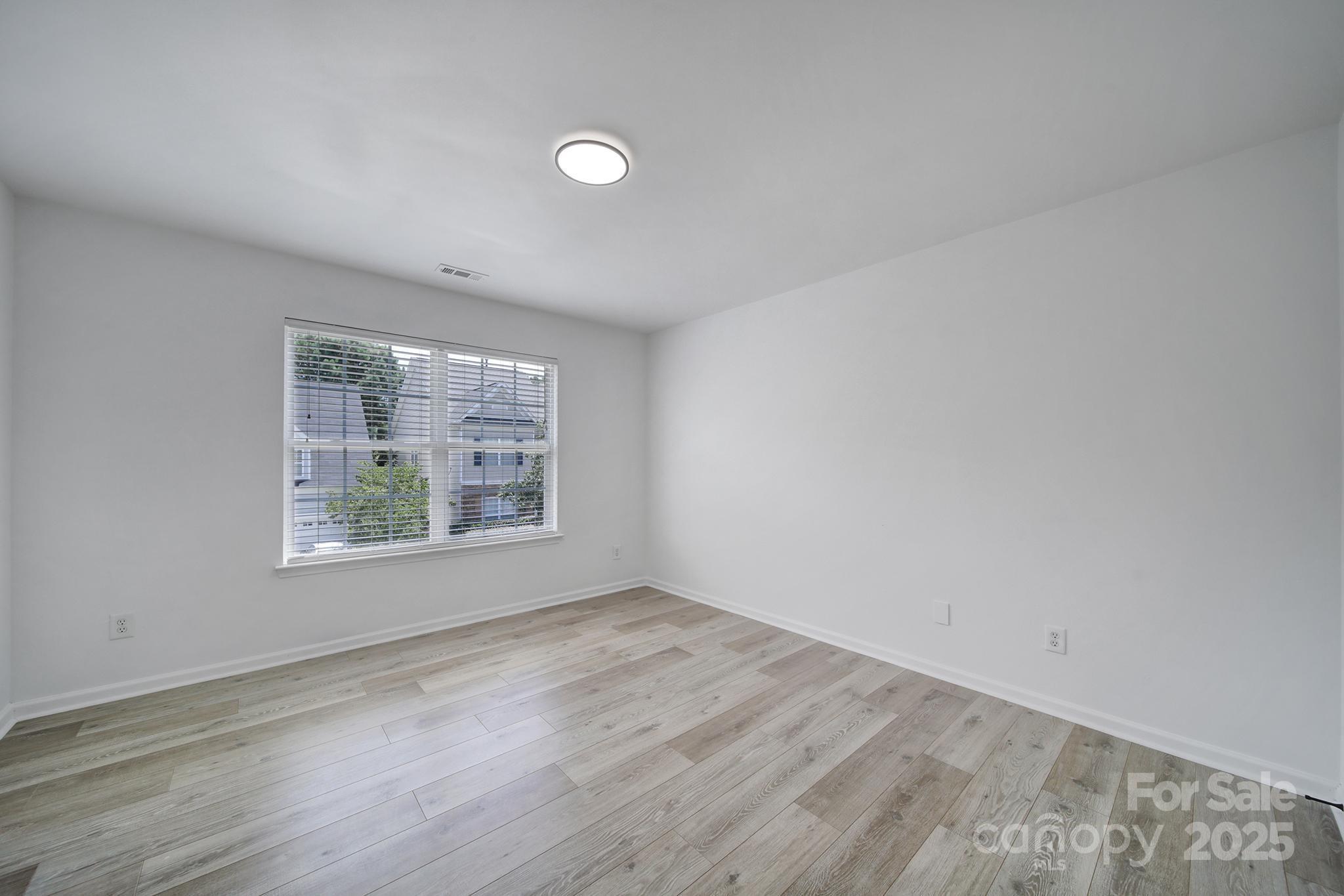 13425 Meadowmere Road Huntersville, NC 28078 - Photo 22 of 41 an empty room with wooden floor and windows