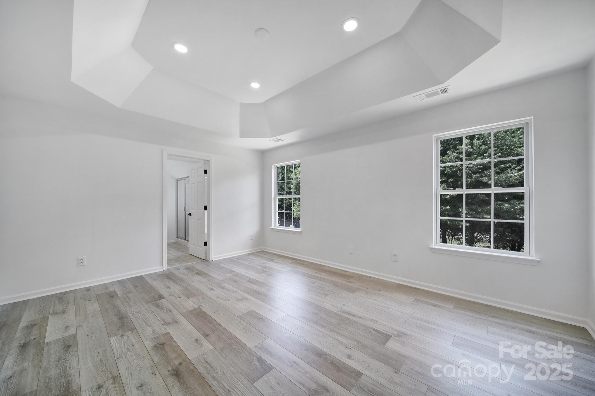 13425 Meadowmere Road Huntersville, NC 28078 - Photo 27 of 41 an empty room with wooden floor and windows
