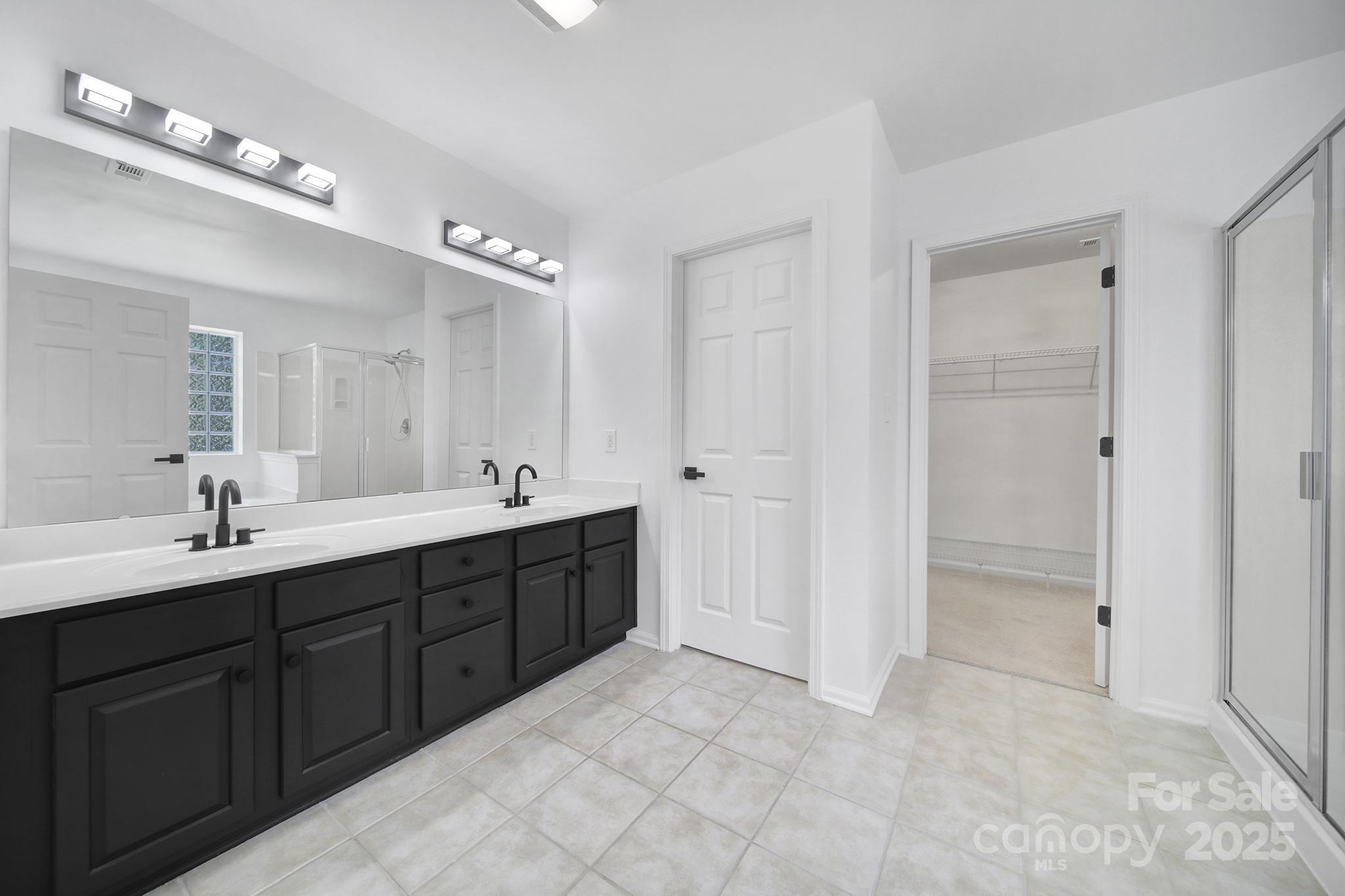 13425 Meadowmere Road Huntersville, NC 28078 - Photo 30 of 41 a spacious bathroom with a double vanity sink shower and a mirror