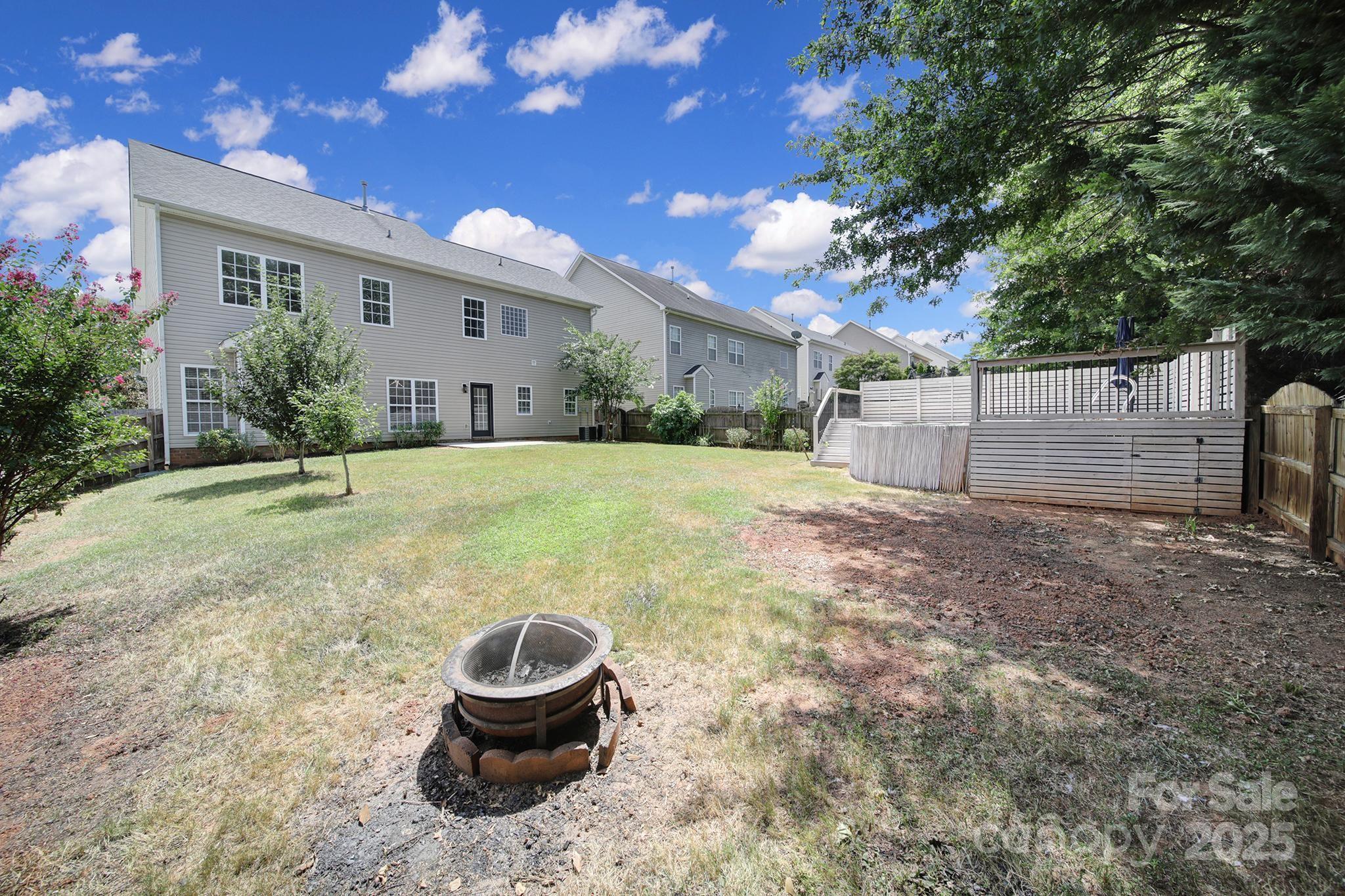 13425 Meadowmere Road Huntersville, NC 28078 - Photo 37 of 41 a backyard of a house with barbeque oven fire pit table and chairs