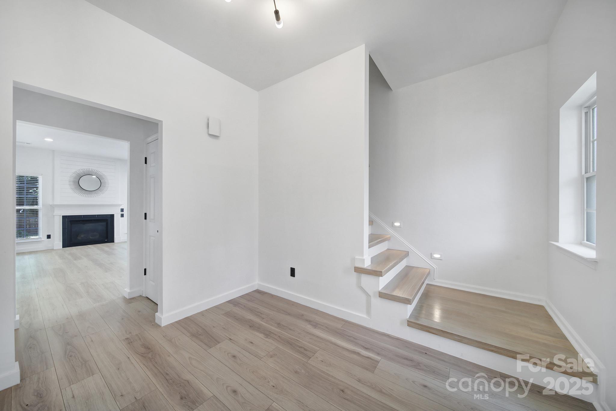 13425 Meadowmere Road Huntersville, NC 28078 - Photo 4 of 41 an empty room with wooden floor and windows
