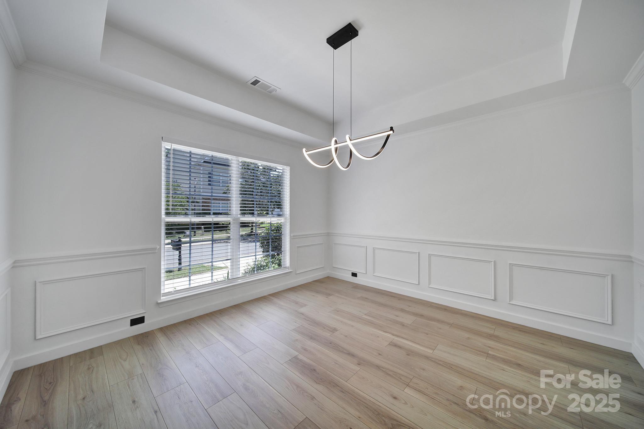 13425 Meadowmere Road Huntersville, NC 28078 - Photo 5 of 41 a view of an empty room with wooden floor and a window