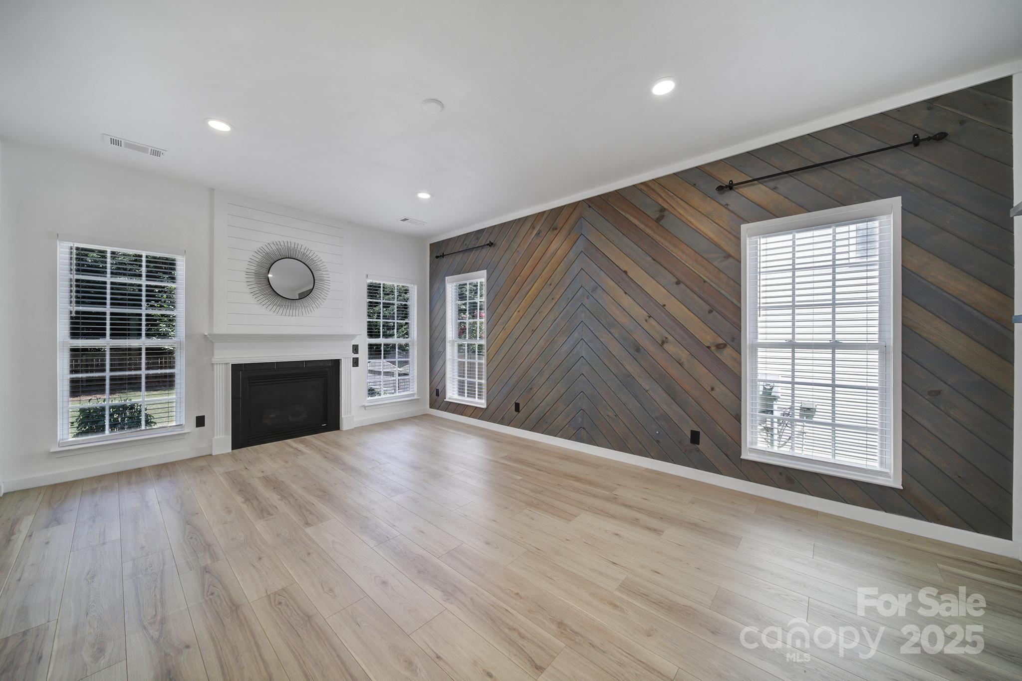 13425 Meadowmere Road Huntersville, NC 28078 - Photo 7 of 41 an empty room with windows and fireplace